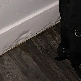 Water damage on wall behind bathroom.