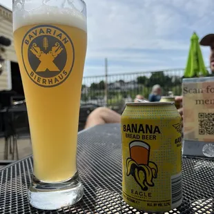 a glass of banana beer and a can of banana