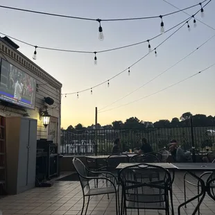 a patio with tables and chairs