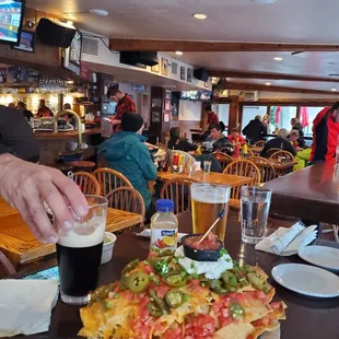 a person serving a large pizza