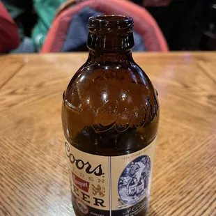 a bottle of beer on a wooden table