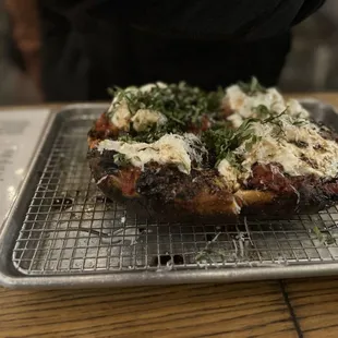 a pizza on a cooling rack