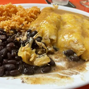 Shredded spicy chicken enchiladas with black beans and rice