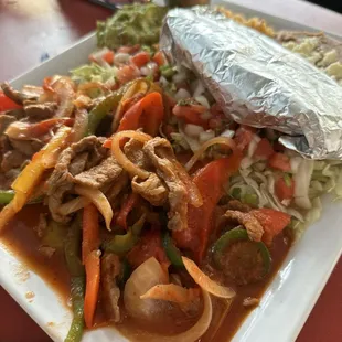 a plate of food with meat and vegetables