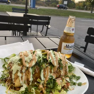 a plate of salad and a bottle of beer
