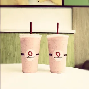 two smoothie cups on a table