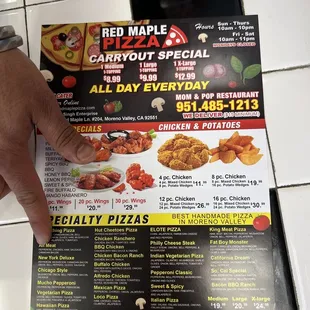 a hand holding a menu