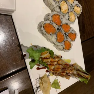 a plate of sushi and rolls