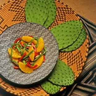 Tender Nopal cactus pad salad served with roasted red bell peppers and sweet juicy citrus segments.