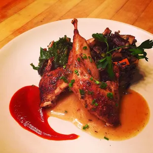Marinated quail with a red chile honey glaze, sautéed greens, and a wild rice sauté.