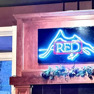 neon sign above fireplace