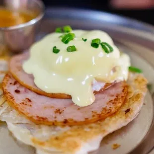 a plate of food with ham and cheese