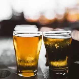 two glasses of beer on a table