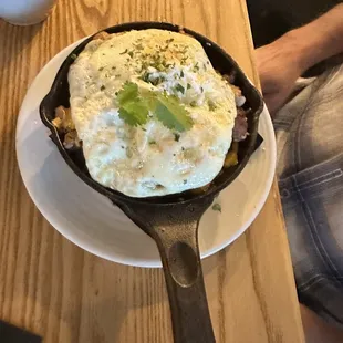 a cast iron skillet with a fried egg on top