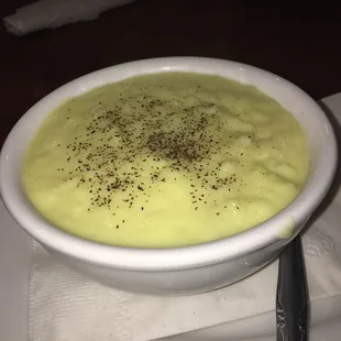a bowl of soup on a white plate