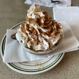 a cup of coffee topped with whipped cream