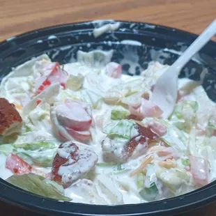 Salad drowning in ranch dressing.