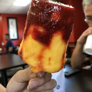 a person holding a piece of food