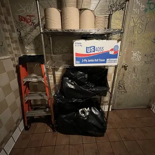 Utensils in trash bag in men&apos;s restroom.