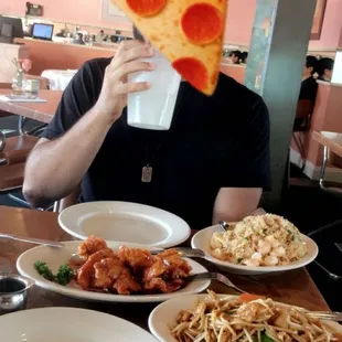 a man eating a slice of pizza