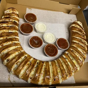 a hot dog and dipping sauces