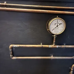 a close up of a pressure gauge and pipes