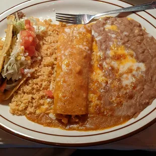 Two item combo shredded beef taco and chicken enchilada with beans and rice.