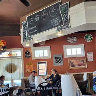 people sitting at tables in a restaurant