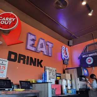 a woman standing at a counter in a restaurant