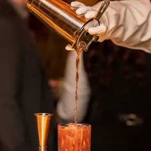 a bartender pouring a drink