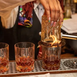 a bartender pouring a drink