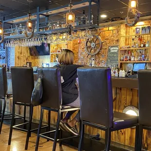 a woman sitting at the bar