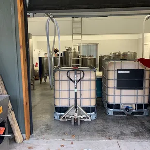 a man standing in front of two barrels