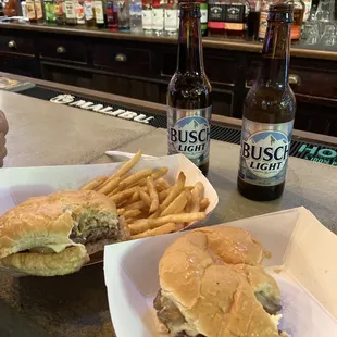 Mushroom and Swiss burgers with battered fries with cold beer.