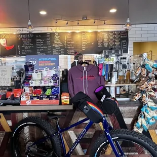 a woman sitting on a bike in a cafe