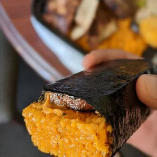 a hand holding a piece of food
