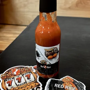a bottle of hot sauce and stickers