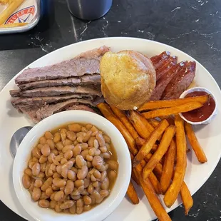 Moist brisket with spicy sausage and sweet potato fries and baked beans. Jalapeño corn muffin.