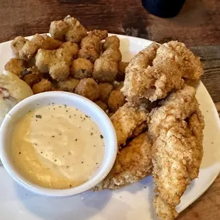 Chicken Tenders dinner with mashed potatoes and cream gravy and fried okra.