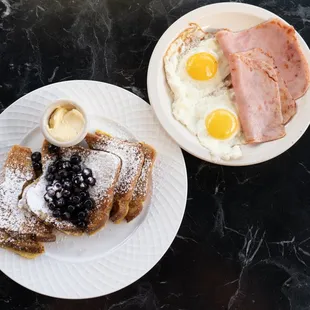 two plates of breakfast food