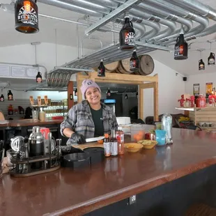 a woman behind the bar