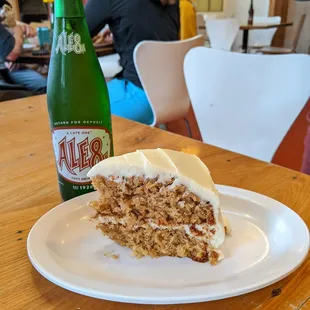 a slice of carrot cake and a bottle of alero