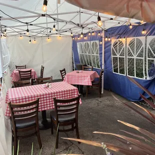 tables and chairs under a tent