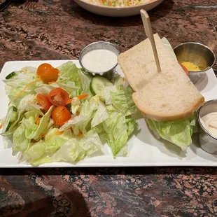 Half Turkey sandwich with a salad.