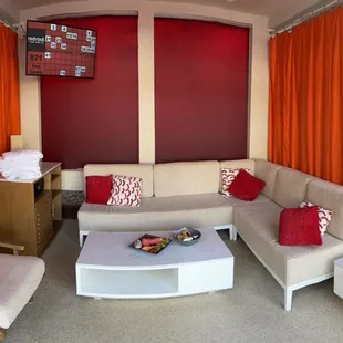 a living room with red curtains