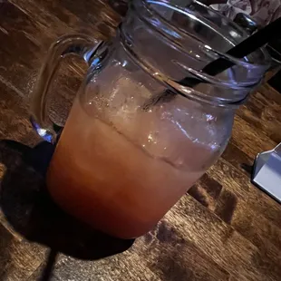 a drink in a mason jar on a wooden table