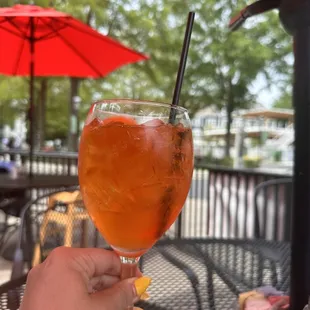  a person holding a glass of drink