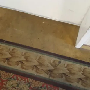 Filthy carpet by elevators