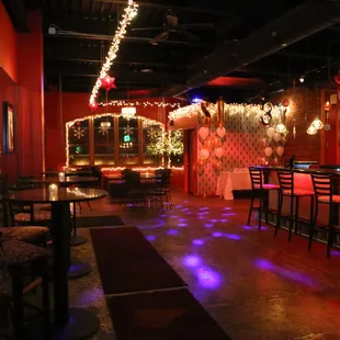 a bar with red walls and chairs