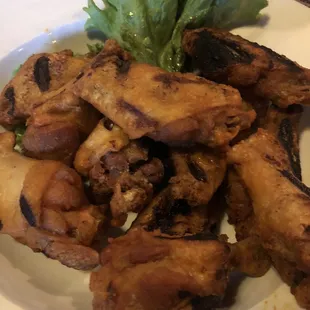 a plate of chicken wings and lettuce